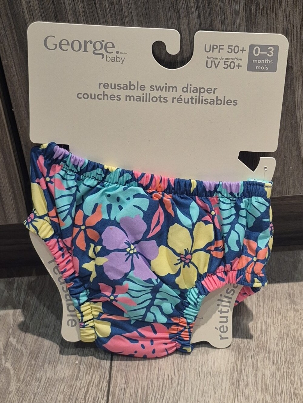 George Baby Reusable Swim Diaper In A Floral Navy Print With UPF 50+ Rating